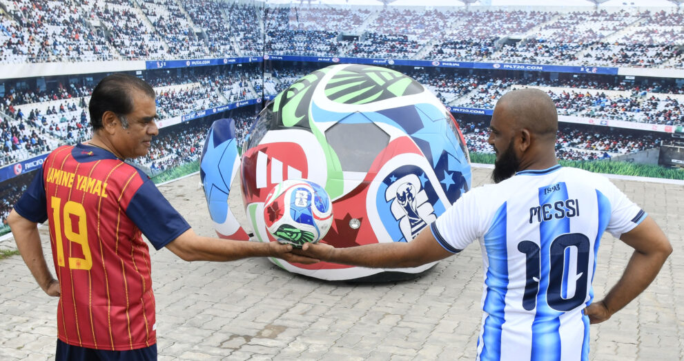 Onlookers watch as the FIFA World Cup-themed Soccer Ball Car drives along the road after its unveiling at Sudha Cars Museum, Bahadurpura Cross Roads, Hyderabad, on Saturday.