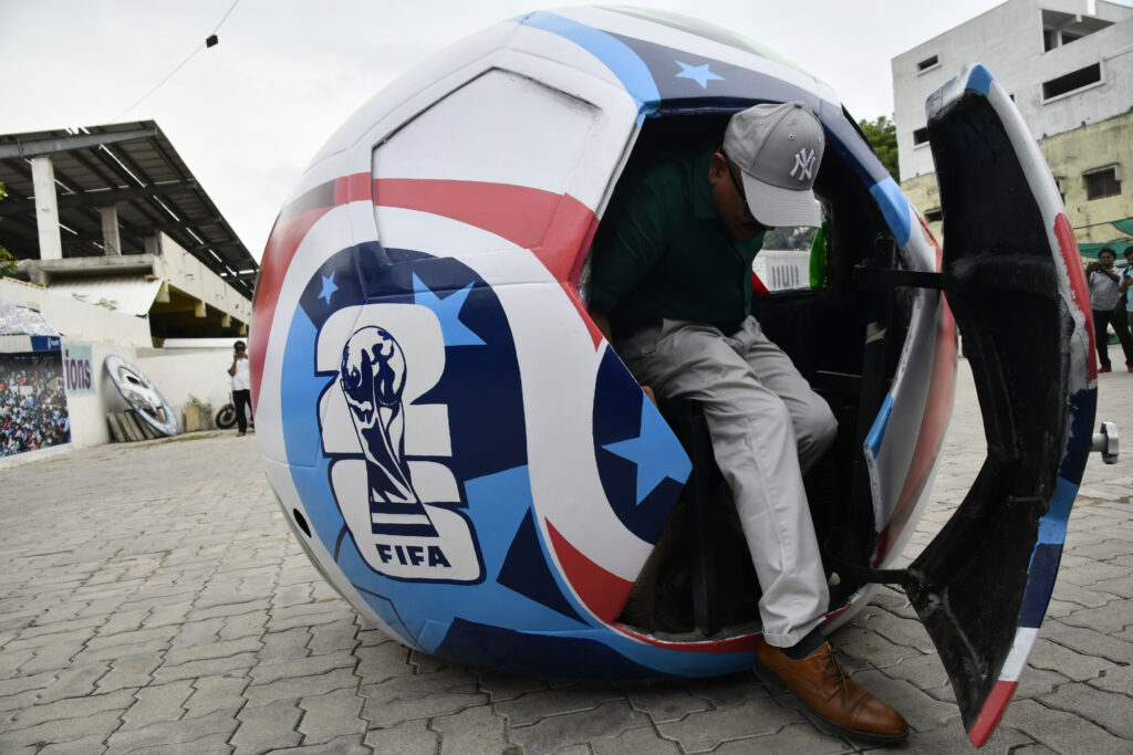 Image 8: The FIFA World Cup-themed Soccer Ball Car drives along the road after its unveiling at Sudha Cars Museum, Bahadurpura Cross Roads, Hyderabad, on Saturday. 